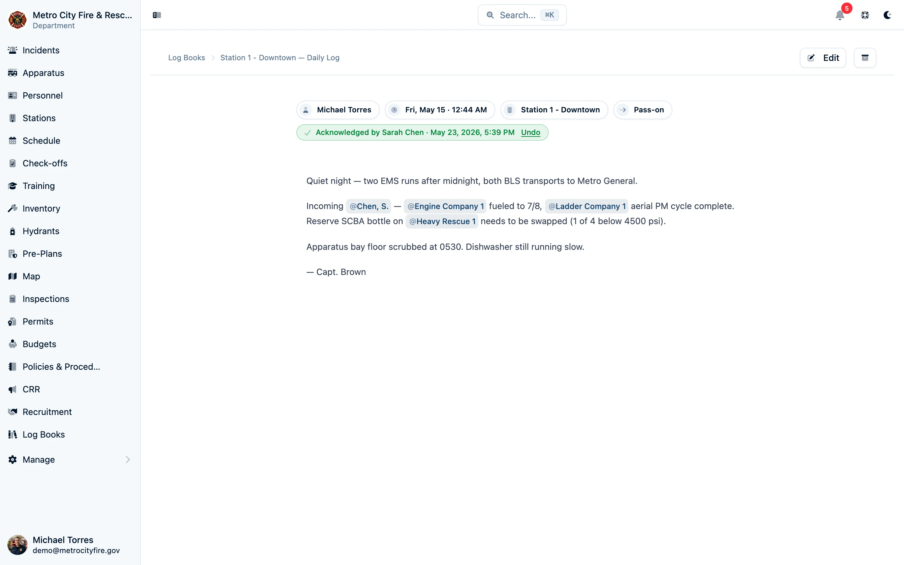 A finished Command Established pass-on log entry rendered with rich text and @-mentions, with the entry type, author, timestamp, and an acknowledgement from the oncoming officer shown at the top